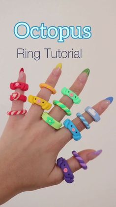 a person's hand with rings made to look like animals and letters on them