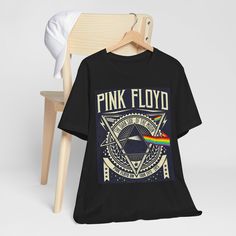 This band shirt in pink featuring a play on the iconic Pink Floyd logo is a must-have for music lovers. The lightweight and breathable 100% cotton fabric makes it perfect for everyday wear, whether you're going to a concert or just hanging out with friends. The retail fit and classic crew neckline add a stylish touch, making it versatile for any casual or semi-formal setting. Perfect for fans of Pink Floyd and music enthusiasts alike. Product features - Made with 100% Airlume combed and ring-spun cotton - Retail fit perfect for casual and semi-formal settings - Lightweight and breathable fabric - Manufactured in a humane, sustainable way by Bella+Canvas - Available in a variety of fabric blends for added versatility Care instructions - Machine wash: cold (max 30C or 90F) - Non-chlorine: bl Pink Floyd Logo, Vintage Band Shirts, Pink Floyd Shirt, Concert Festival, Band Shirt, Music Concert, Vintage Band, Band Shirts, Pink Floyd