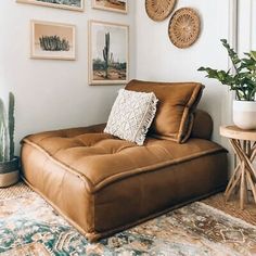 a living room with pictures on the wall and a couch next to a coffee table