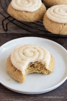 some cookies with frosting on a white plate