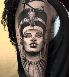 a woman's arm with a black and white tattoo design on her left shoulder