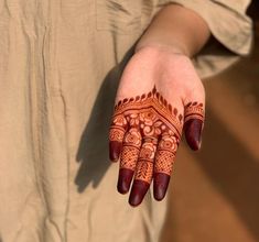 a woman's hand with henna on it