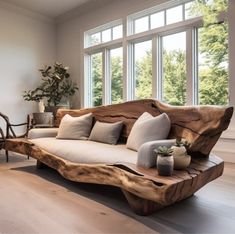 a living room filled with furniture and large windows