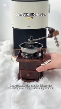 the coffee mill grinder is sitting on top of a white furnishing area