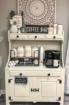 a coffee bar with white cabinets and black accents