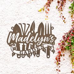 the word madelyn's hill is surrounded by vines and ivys on a white wall