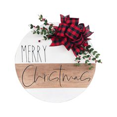 a wooden sign that says merry christmas with a red bow on it and greenery