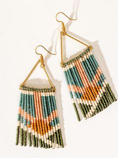 An elongated version of one of our best-selling beaded earrings (the Neon Fringe Earring), the faithful fringe statement earrings evoke the beauty of the sunset and sunrise through an eye-catching combination of colors. Delicate glass beads in a bright or moody design will make a striking addition to your outfit as these colorful earrings swing and sway with your movement! Free Beaded Fringe Earring Patterns, Beaded Fringe Earrings Tutorial, Fringe Earring Pattern, Fringe Earrings Diy, Beading Board, Sunset And Sunrise, Moody Design, Fringe Beaded Earrings, Earring Displays