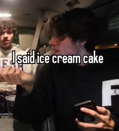 two men standing next to each other in front of a cake with the words i said ice cream cake on it