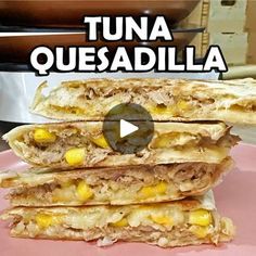 a pink plate topped with three quesadillas on top of each other and the words tuna quesadilla