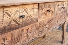 an old wooden dresser with carvings on it