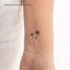 a small palm tree tattoo on the wrist