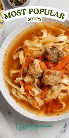 a white bowl filled with pasta and meat soup on top of a marble countertop