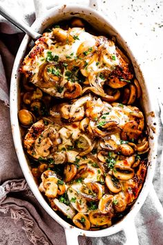 a casserole dish filled with chicken, mushrooms and cheese