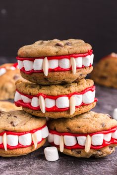 chocolate chip cookies with white marshmallows and monster teeth are stacked on top of each other