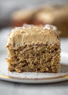 a piece of cake sitting on top of a white plate with frosted icing