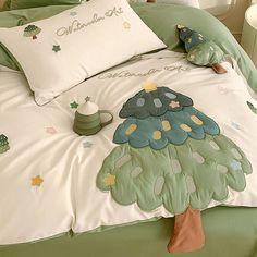 a bed with green and white comforters on it