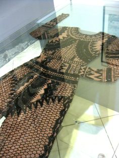 an elaborately designed piece of cloth on display in a glass case at the museum