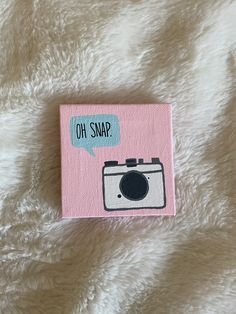 a pink card with a camera on it that says oh snap