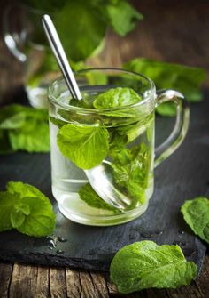 fresh mint tea in a glass mug with a spoon