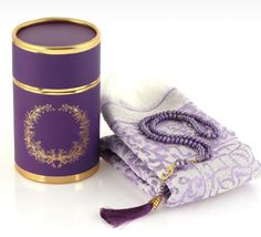 a purple box with a tassel on it next to some beads and napkins