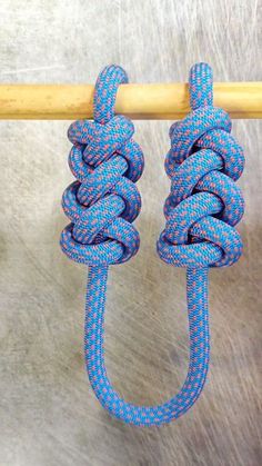 two blue ropes attached to a wooden pole