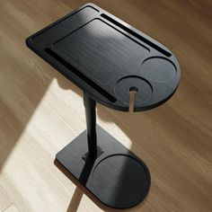 a black table sitting on top of a wooden floor