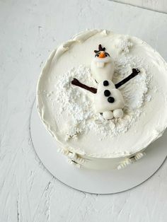 there is a frosted cake with a snowman on it