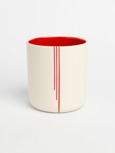 a white and red cup sitting on top of a table