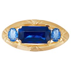 This large brooch is a real head-turner. Mostly likely designed in pre-war Czechoslovakia, so 1930s, it is crafted from a gold-toned metal and features flamboyant and very large glass stones. The central stone is a rich royal blue and cut to a rectangular shape. It is flanked by two oval-cut stones in cornflower blue. The setting is decadent with paw-shaped claws holding the central stone in place. The edge of the brooch is elaborately carved. Unsigned but a quality and striking peice. In very good vintage condition with a tiny bit of wear to the gold and some foiling to the reverse of one of the stones. This is only noticed with the brooch in hand and not while being worn. We have shown a picture of this with bright studio lights shining through. MEASUREMENTS: LENGTH - 3.75 in. (9.5 cm) W Broche Chanel, Cornflower Blue, Gold Tone Metal, Valentino Garavani, Royal Blue, Gold Tones, Carving, Stone, Blue