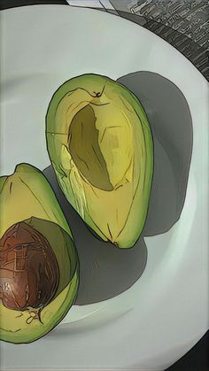 an avocado cut in half on a plate