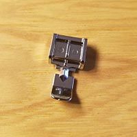 a couple of black clips sitting on top of a wooden table