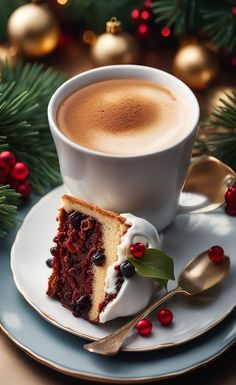 a piece of cake on a plate next to a cup of cappuccino