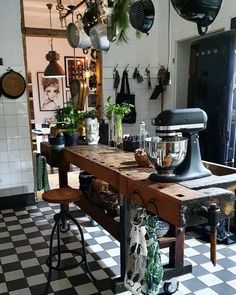 a kitchen filled with lots of pots and pans on top of a wooden table