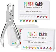 a pair of scissors sitting next to each other with punch cards in front of them