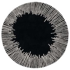 a black and white circular rug with lines on the center, in an oval shape