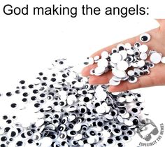 a hand is holding up some white and black buttons with the words god making the angels