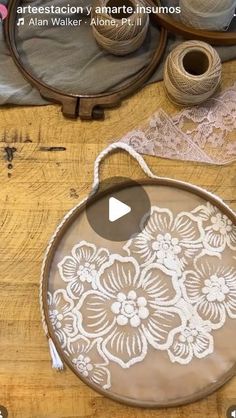 the video is showing how to make an embroidered bag with lace and buttons on it