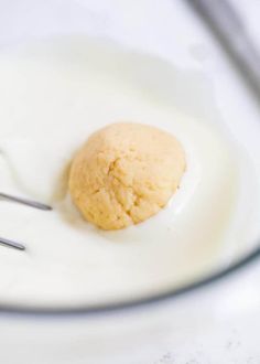 an egg and spoon on a white plate