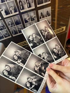 a person holding up some old black and white photos