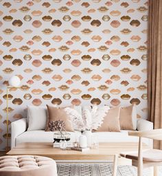 a living room filled with furniture and a wallpaper covered in gold lipstick prints on it