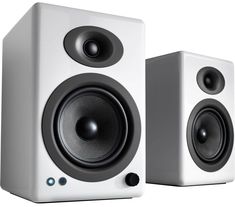 two white speakers sitting next to each other