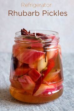 a jar filled with pickles sitting on top of a table