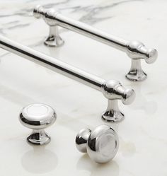 chrome handles and knobs on a marble counter top