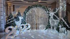 a christmas display in the middle of a room with white lights and decorations on it