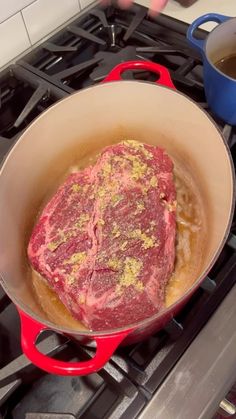 a steak is cooking in a pot on the stove