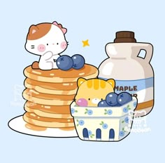 a cat sitting on top of some pancakes next to a jug of maple syrup and a bowl of blueberries