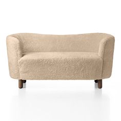 a beige couch sitting on top of a white floor