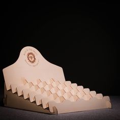 a bed made out of cardboard with an emblem on the headboard and foot board