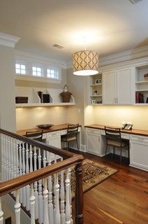 an open concept kitchen with white cabinets and wood flooring is featured in this image